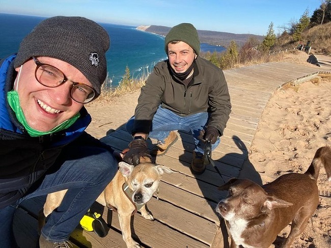 chasten and his husband with their dogs
